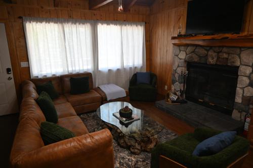 a living room with a couch and a fireplace at Bear House in Big Bear City