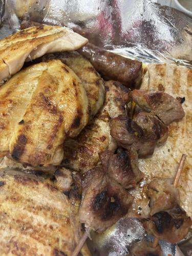 a plate of food with meat and sausage at Etno kuća Biblioteka in Smederevo