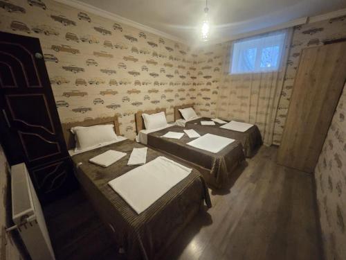 a room with two beds and a window at NISS House in Akhaltsikhe