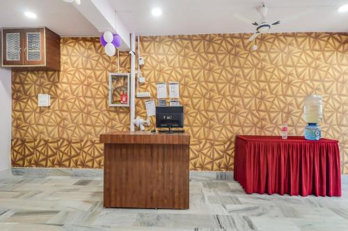 a room with two tables and a wall with gold wallpaper at Hotel RUDRA INN in Rānchī