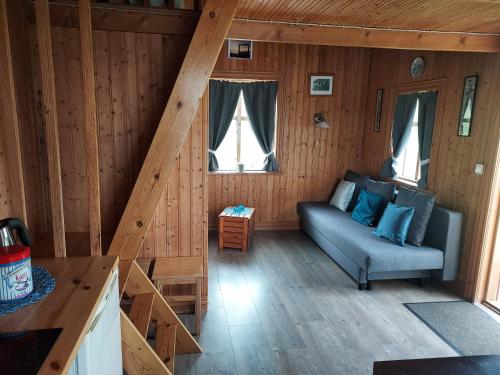 a living room with a couch in a cabin at Hænuvík Cottages in Örlygshöfn