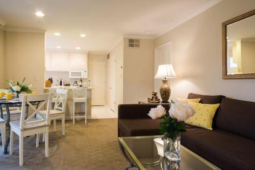 a living room and kitchen with a couch and a table at The Napa Residences in Napa