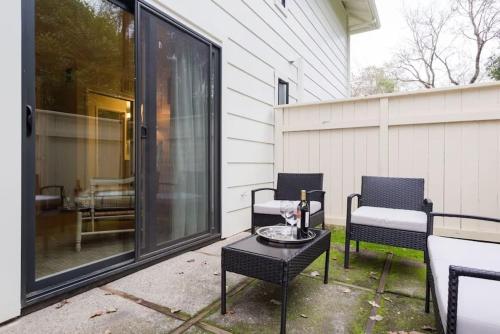 a patio with two chairs and a table on a porch at The Napa Residences in Napa