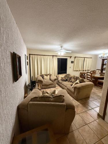 a living room with two couches and a couch at Casa La Cañada216 con Alberca Climatizada in Cuernavaca