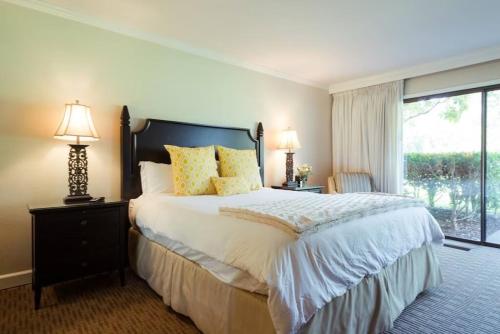 a bedroom with a large bed and a large window at The Napa Residences in Napa