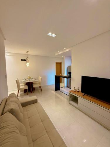 a large living room with a couch and a table at Conforto e praticidade em região central de Belém in Belém