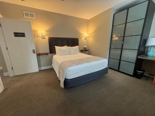 a hotel room with a bed and a large window at Bexley Bed and Breakfast in Columbus