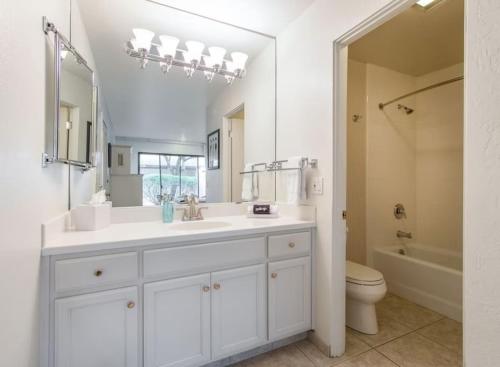 a white bathroom with a sink and a toilet at The Napa Residences in Napa