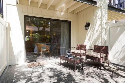 a patio with two chairs and a table on a house at The Napa Residences in Napa