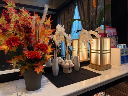 a table with flowers and candles on a table at APA Hotel Shin Osaka Ekiminami in Osaka