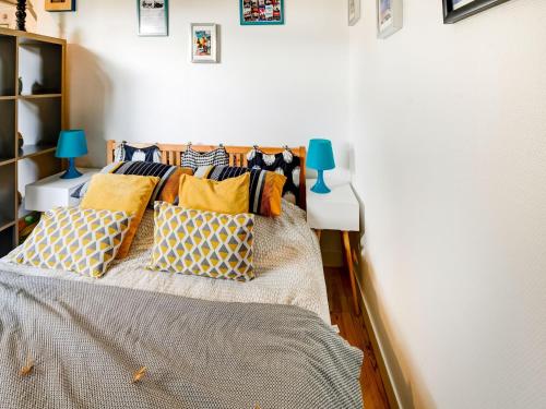 a bedroom with a bed with pillows on it at Romantic Escape in Normandy in Isigny-sur-Mer