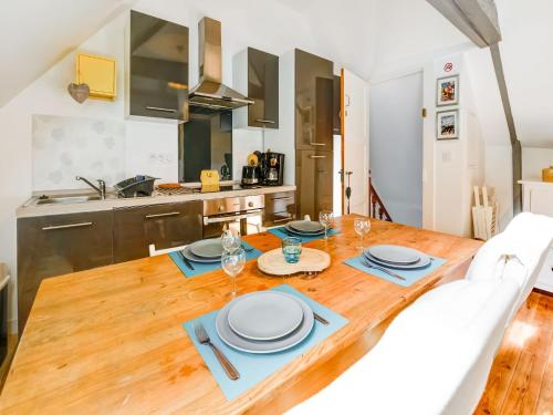a kitchen and dining room with a wooden table at Romantic Escape in Normandy in Isigny-sur-Mer