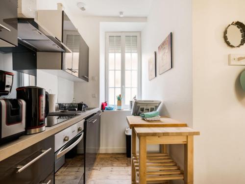a small kitchen with a wooden table in it at Seaside Serenity in Normandy in Isigny-sur-Mer