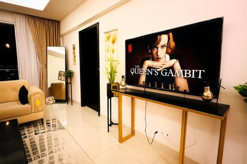 a living room with a flat screen tv on a wall at Montressa Hotel Apartments-Elysium Tower Opposite Centaurus Mall Islamabad in Islamabad