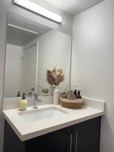 a bathroom with a sink and a large mirror at The Hollywood Blvd Loft FREE AND DESIGNATED PARKING in Los Angeles