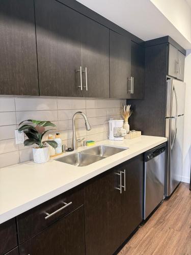 a kitchen with a sink and a refrigerator at The Hollywood Blvd Loft FREE AND DESIGNATED PARKING in Los Angeles