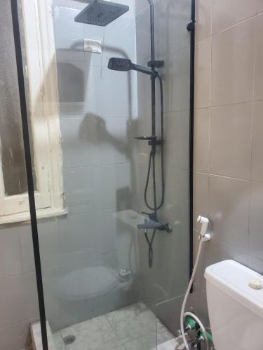 a shower with a glass door in a bathroom at nice comfy bedroom in Cairo