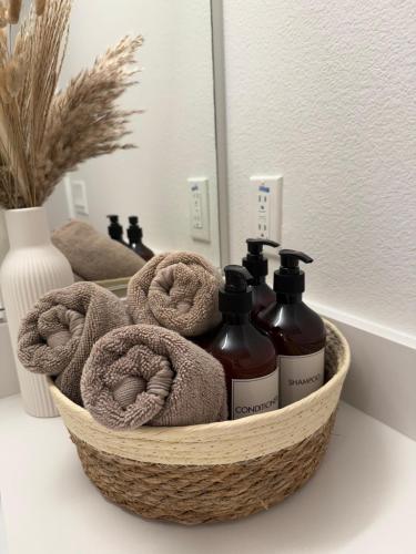 a basket with two bottles of soap and towels at The Hollywood Blvd Loft FREE AND DESIGNATED PARKING in Los Angeles