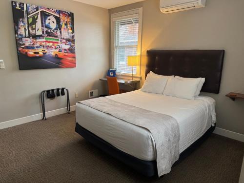 a bedroom with a large bed with a white bedspread at Bexley Bed and Breakfast in Columbus