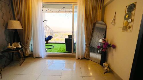 an open door with a view of a yard at Montressa Hotel Apartments-Elysium Tower Opposite Centaurus Mall Islamabad in Islamabad