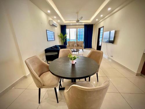 a dining room with a table and chairs at Montressa Hotel Apartments-Elysium Tower Opposite Centaurus Mall Islamabad in Islamabad