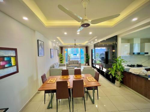 a living room with a dining table and a couch at Montressa Hotel Apartments-Elysium Tower Opposite Centaurus Mall Islamabad in Islamabad