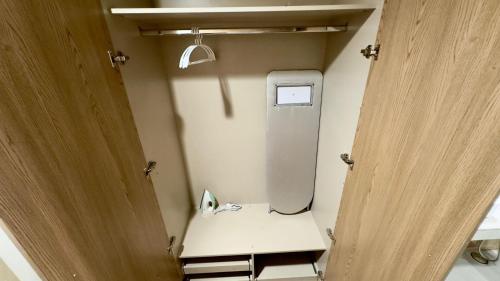 a bathroom with a toilet in a small room at Montressa Hotel Apartments-Elysium Tower Opposite Centaurus Mall Islamabad in Islamabad