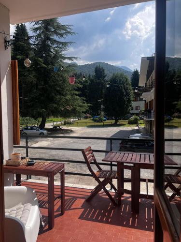 a patio with a table and chairs and a view of a street at Relax, Comfort & Alps Adventures in Chiusa di Pesio
