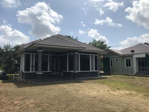 a house with a green at Ara Twin Homestay MelorKotaBharu 