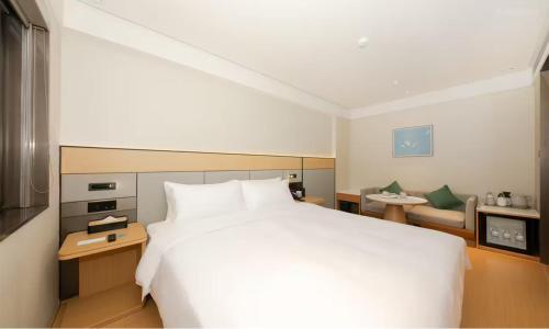 a large white bed in a hotel room at JI Hotel Beijing West Railway Station Lize Business District in Beijing