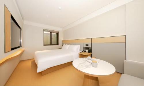 a hotel room with a bed and a table at JI Hotel Beijing West Railway Station Lize Business District in Beijing