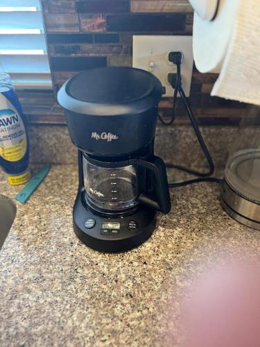 a coffee maker sitting on a kitchen counter at Pet-Friendly 5BR Near Hospital & TRAX with Projector in Murray