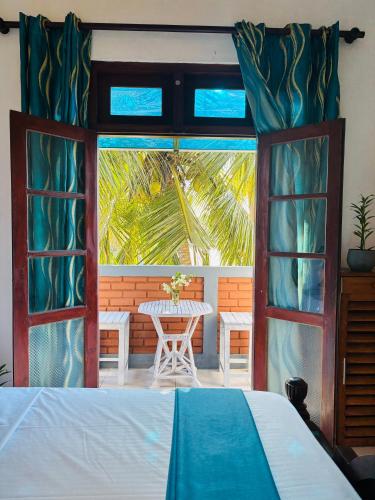 a bedroom with a bed and a table and a window at SENUKi in Galle