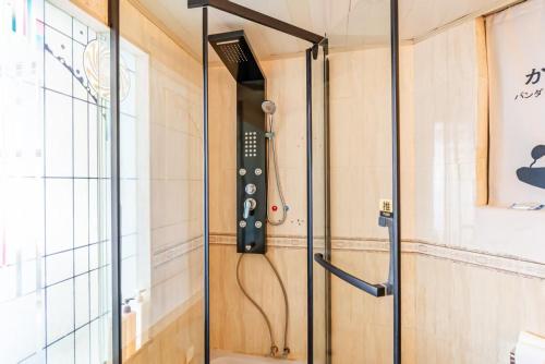 a shower in a room with a glass door at Jinxin Nanguo in Chongqing
