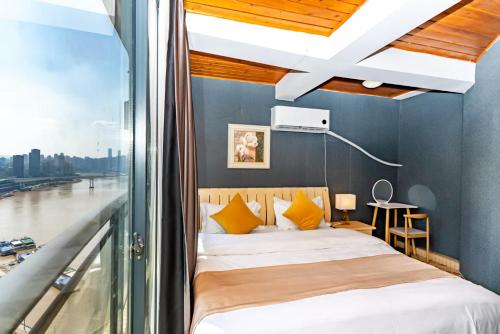 a bedroom with a bed with yellow pillows and a window at Jinxin Nanguo in Chongqing