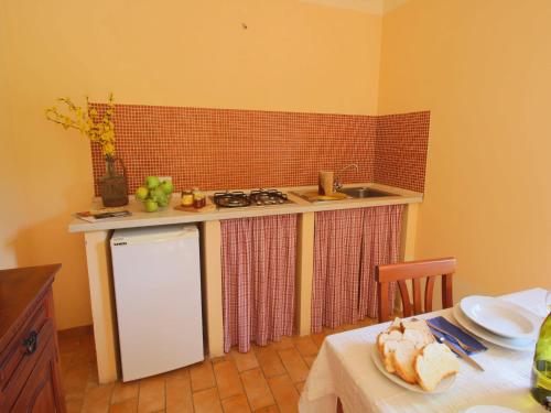 a kitchen with a counter and a sink and a table at Apartment in Marche with Pool & Terrace in Apecchio