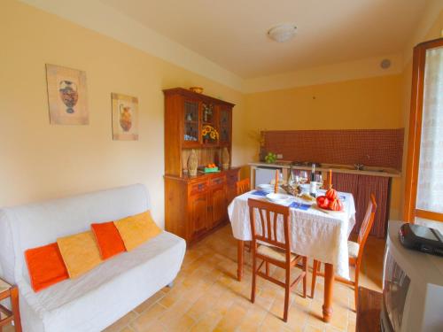 a living room with a table and a kitchen at Apartment in Marche with Pool & Terrace in Apecchio