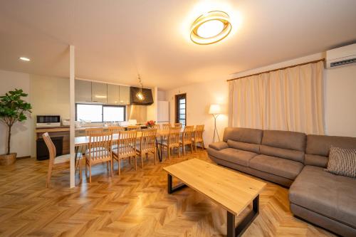 a living room with a couch and a table at アリュール別府 in Beppu