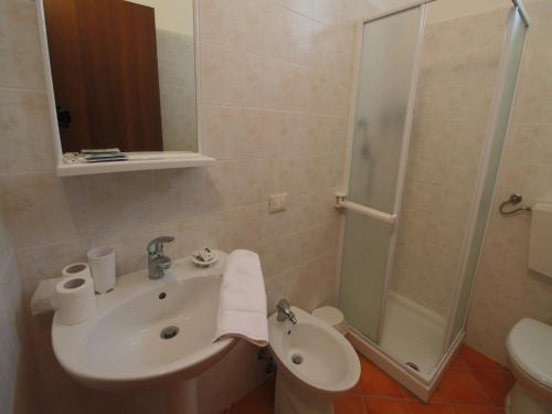 a bathroom with a sink and a shower at Hill View Retreat w Pool in Apecchio