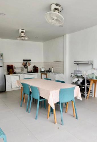 a kitchen with a table and chairs in a room at Colmar PoolVilla Khao Yai in Wangkata