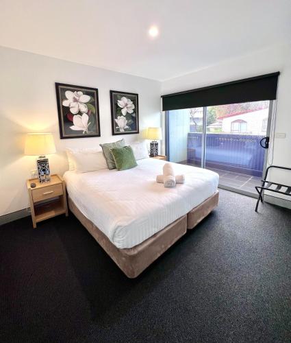 a bedroom with a large bed and a large window at Crown on Darby Newcastle in Newcastle
