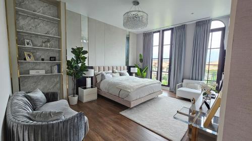 a bedroom with a bed and a chair and a couch at 5-Star Pool Villa 4BR Private Luxury-Sukhumvit in Ban Nong Chaeng
