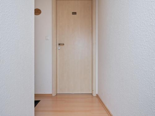 an empty corridor with a door in a room at Attic Apartment with Garden Access in Groß Schwansee
