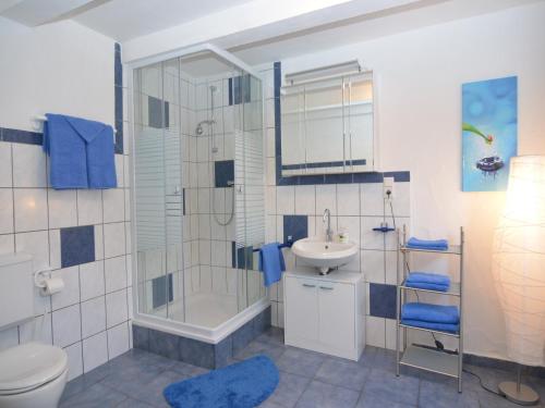 a bathroom with a shower and a sink and a toilet at Gruppenferienhaus im Sauerland in Schmallenberg
