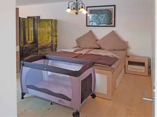 a bedroom with a bed with a tv in it at Ferienwohnung in Wildemann in Wildemann