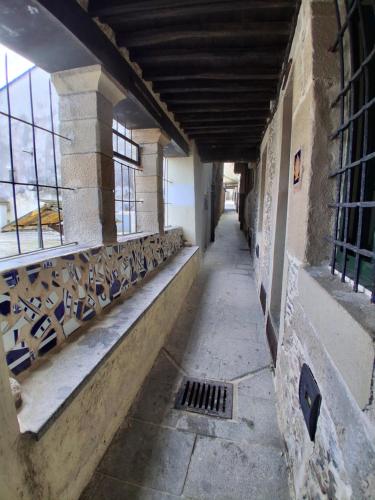 an empty hallway in an old building with windows at A Casa do Calexón in Viveiro