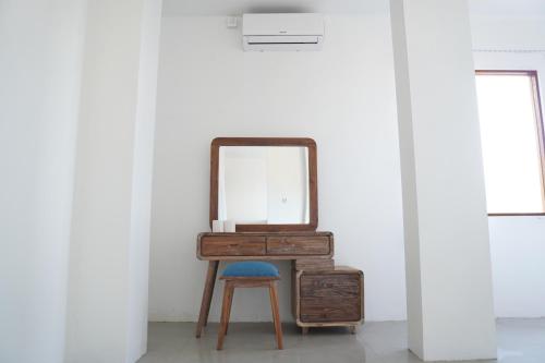 a dressing table with a mirror and a stool at Sky Mountain Views in Kuta Lombok