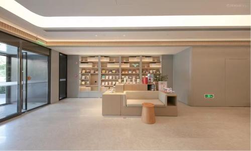 a room with a library with a bench and a table at JI Hotel Beijing West Railway Station Lize Business District in Beijing