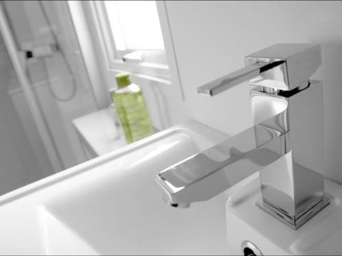 a bathroom sink with a mirror and a green soap bottle at Mobil home confortable avec terrasse pour 6 personnes - API-1-52-304 in Brétignolles-sur-Mer