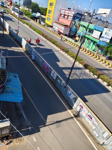 an overhead view of a street with motorcycles on a road at skywayrooms near Indira Gandhi signal in Puducherry